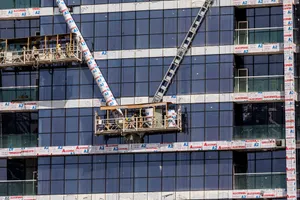Industrial facility construction site with multiple trades working on large structure
