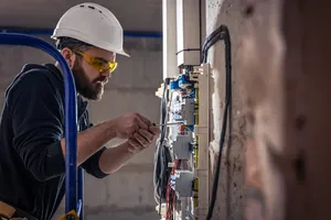 Facility maintenance technician completing preventive maintenance