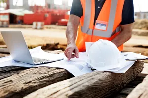 HSE personnel reviewing certifications and safety records on site