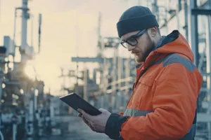 Pipeline maintenance technician inspecting equipment at a remote location