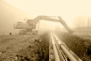 Pipeline construction welding crew working on large diameter pipe in the field