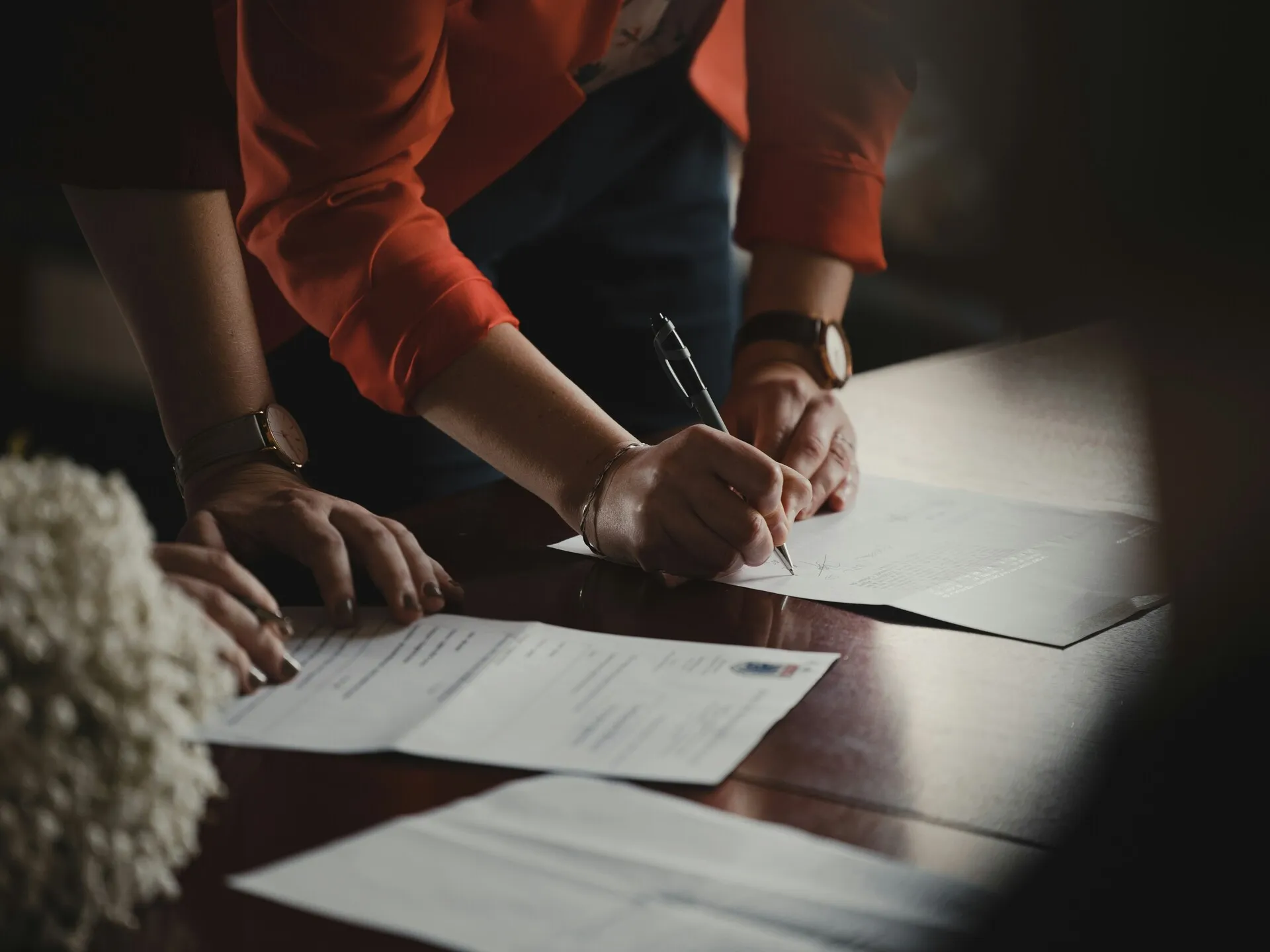 Professionals reviewing and signing documents