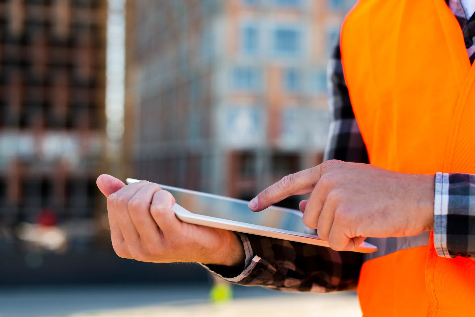 Professional reviewing documents on tablet