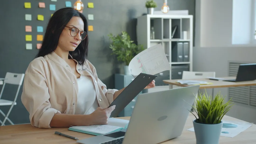Professional reviewing financial documents at desk